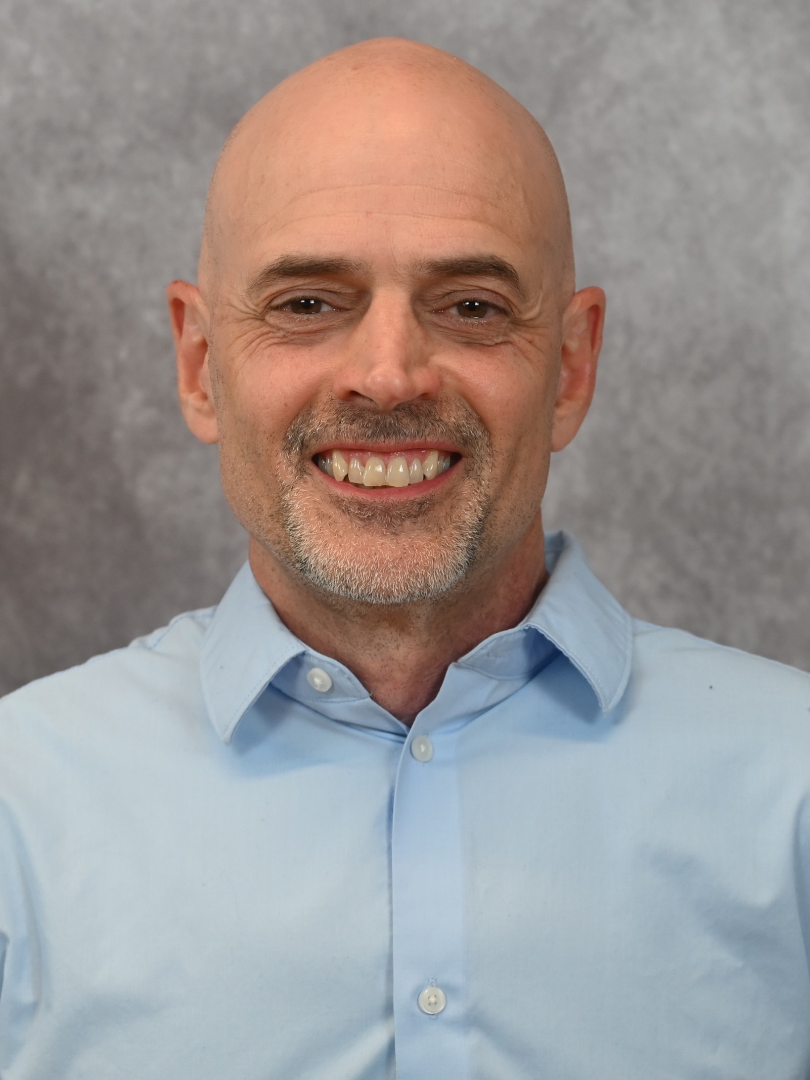 A bald man with blue shirt
