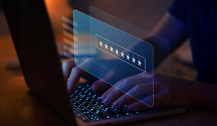 Person entering a password on a laptop