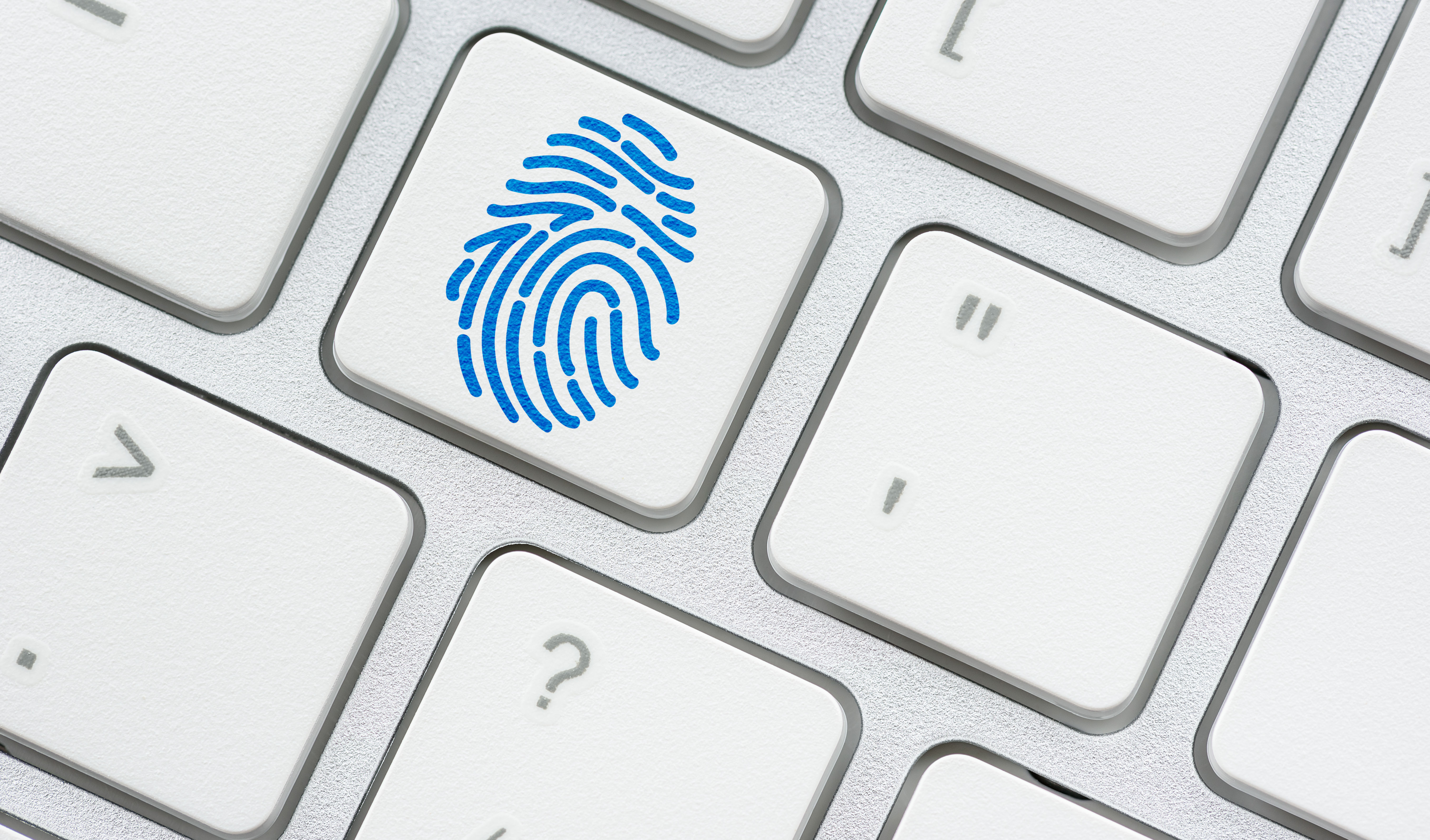 Fingerprint symbol on a surface of a white keyboard