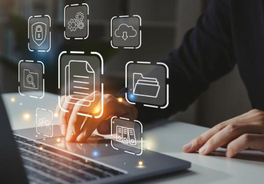 business man working on laptop with icons hovering over keyboard