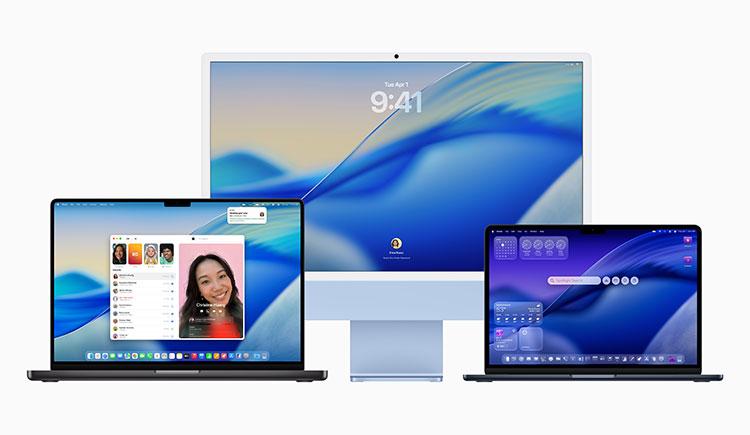 Three Mac computers—two MacBook Pro laptops and a blue iMac—displaying macOS Tahoe's new interface, featuring a flowing blue and teal wave wallpaper across all devices.