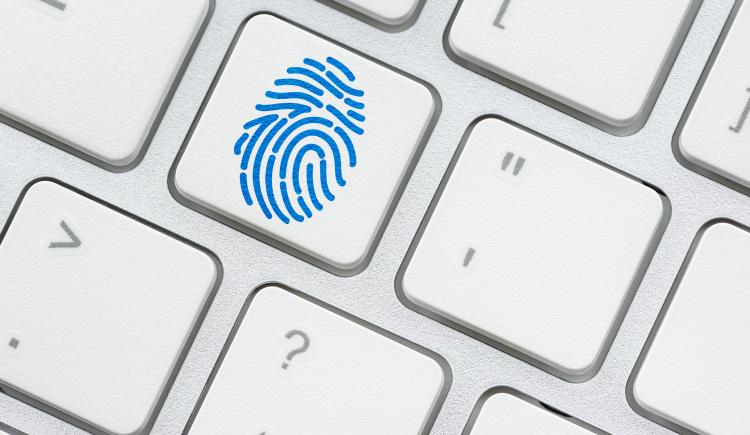 Fingerprint symbol on a surface of a white keyboard