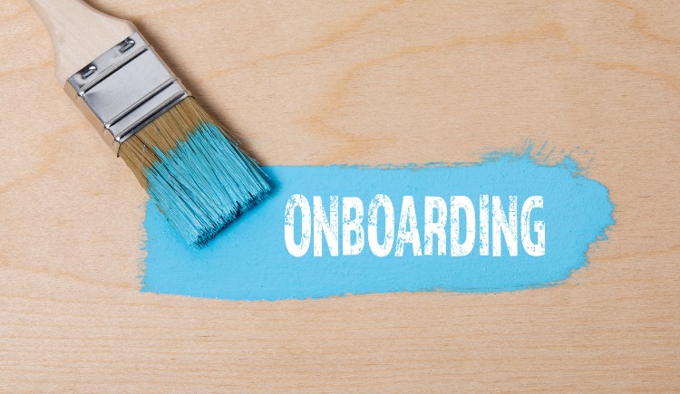 paint brush with blue paint on a wooden surface picture with the words onboarding